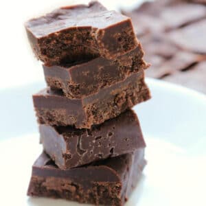 5 pieces of 3 ingredient maple tahini freezer fudge stacked on top of each other