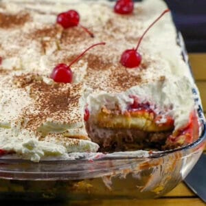 Black Forest Tiramisu in glass pan with piece missing