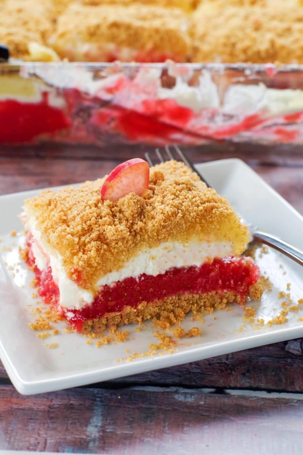 This is a photo of a piece of Rhubarb Dessert served on a white plate - by Food Meanderings