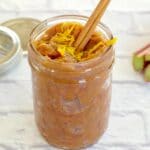 rhubarb compote in a jar with a cinnamon stick and orange zest
