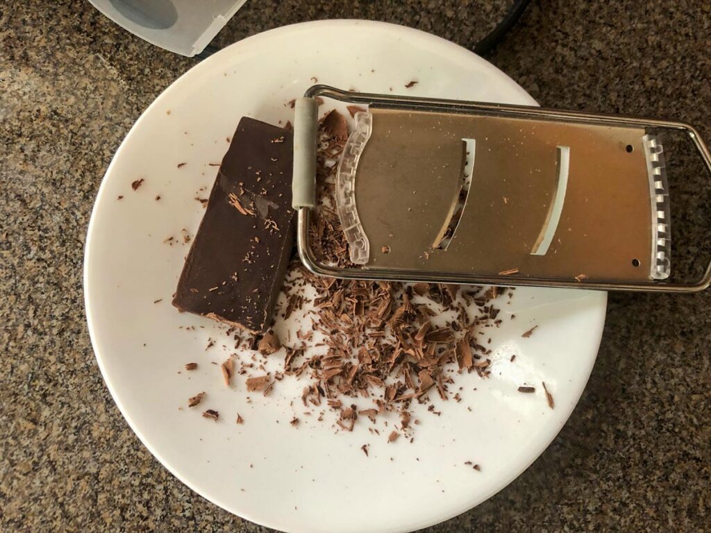 chocolate being shaved onto a plate
