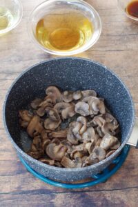 mushrooms cooked with butter and seasoning salt in a pot