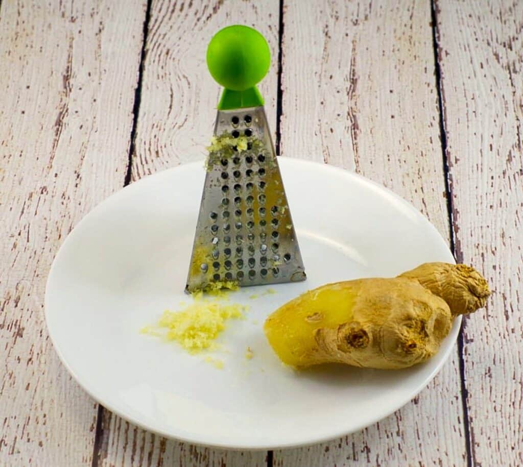 ginger on a white plate with small grater