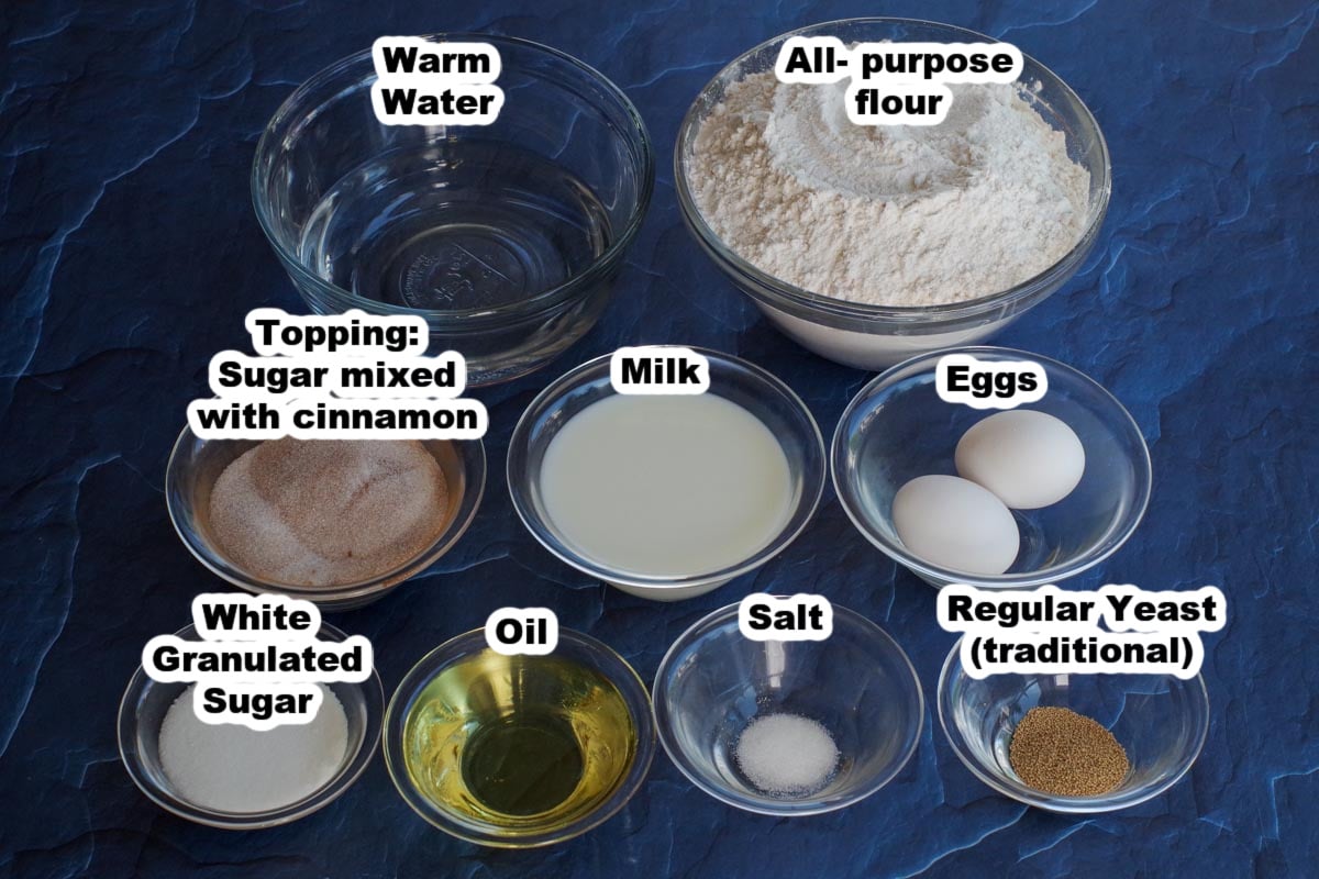Ingredients for pampushky in glass bowls, labelled (on a blue surface)