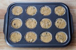 batter in lined muffin pans
