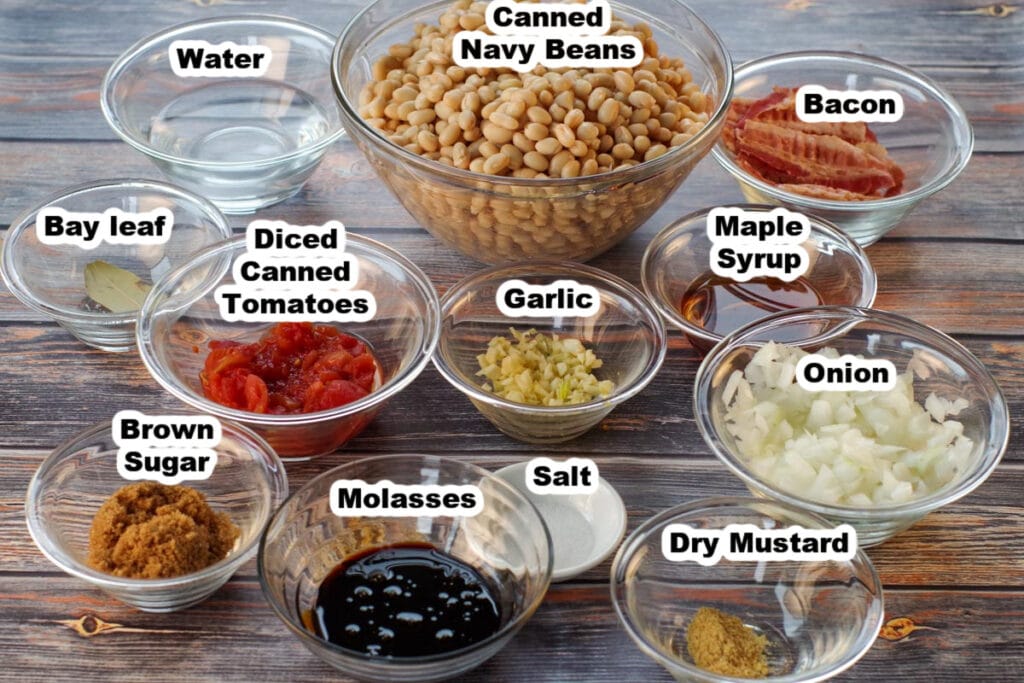 ingredients for slow cooker new england baked beans in glass bowls, labelled