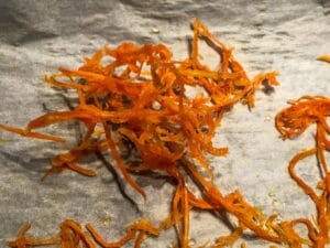 candied carrot dried in clump on parchment paper