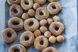 donuts on parchment lined cookie sheet