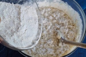 flour gradually being added to mixture