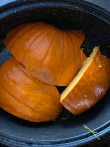 pumpkin cut into wedges in roaster