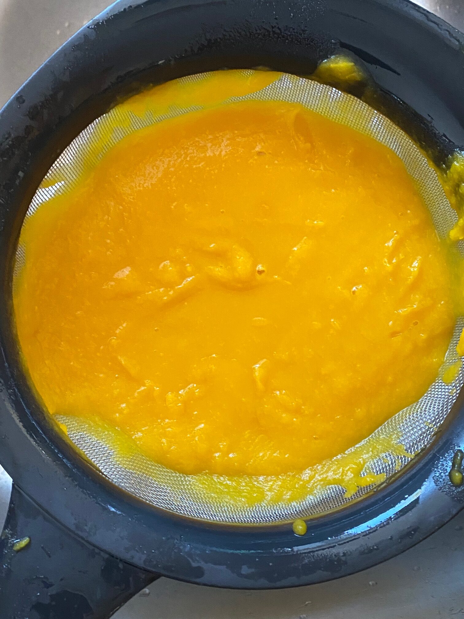 pumpkin puree in a strainer