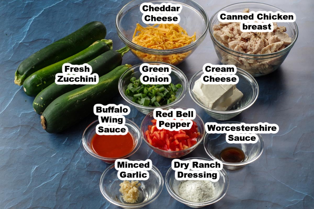 ingredients in buffalo chicken zucchini boats labelled in glass dishes (except zucchini)