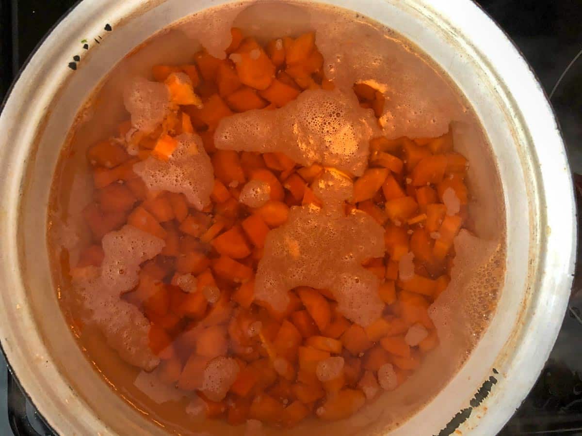 carrots cooking in pot in boiling water