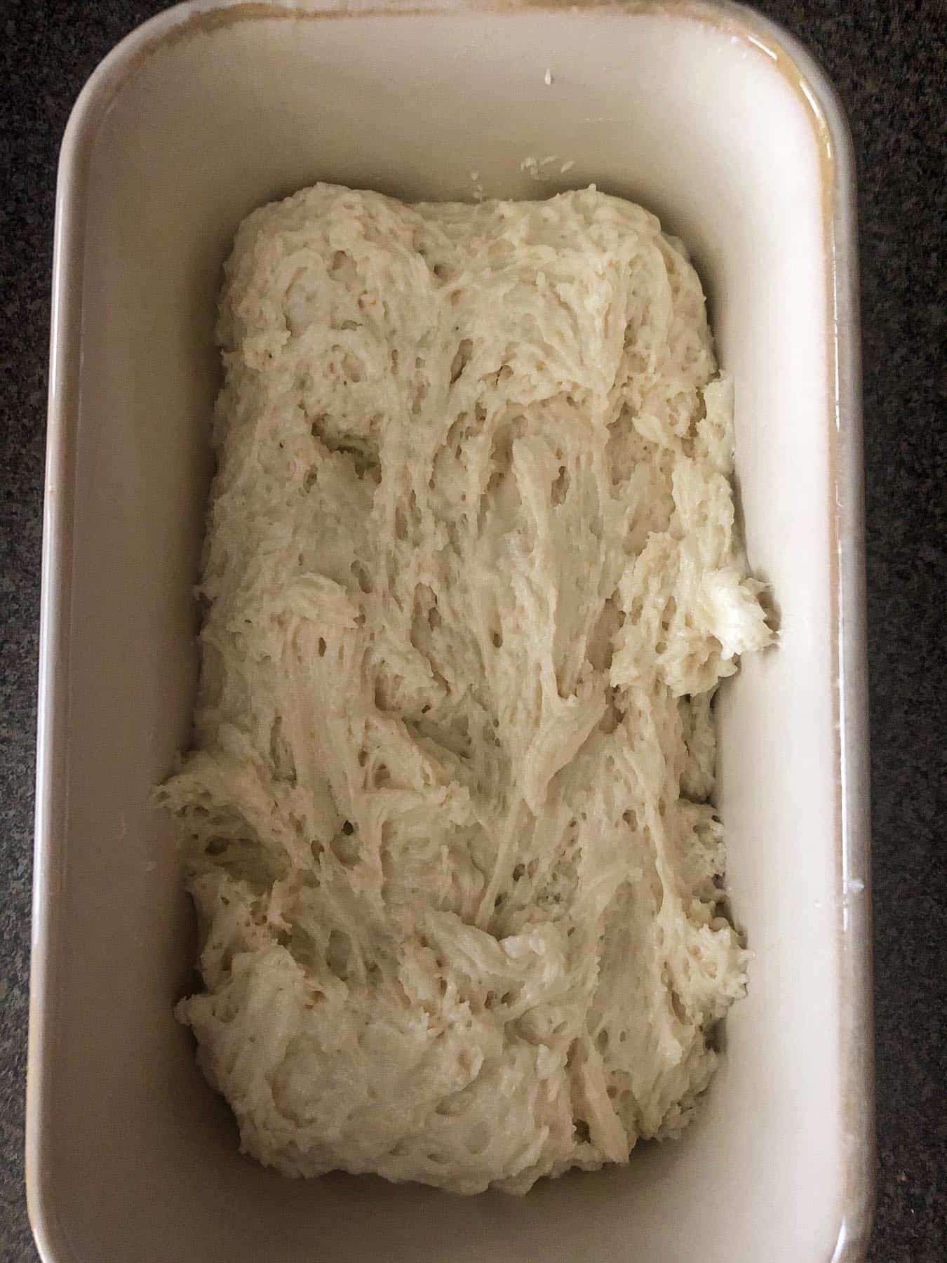 half the batter added to the loaf pan