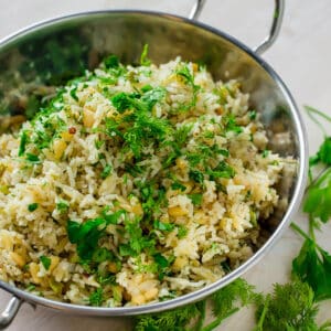 lemon rice in a silver work with dill on the side