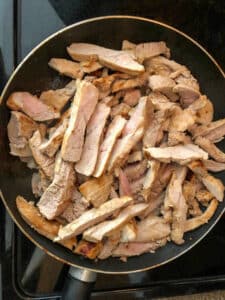 sliced pork in frying pan
