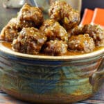 slow cooker sweet and sour meatballs in a hand made pottery serving bowl