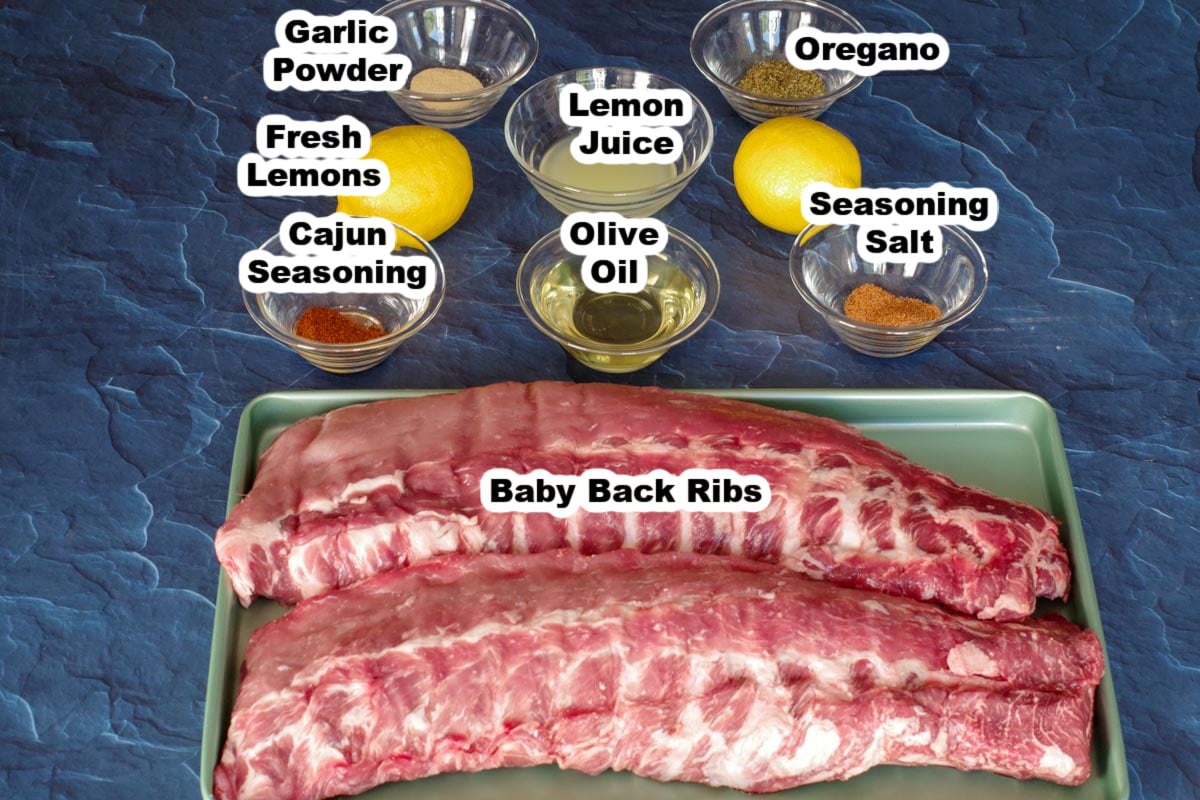 raw ribs on cookie sheet with rest of ingredients in labelled jars in background