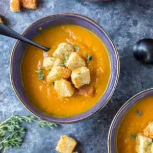 roasted butternut squash soup in blue bowls with croutons