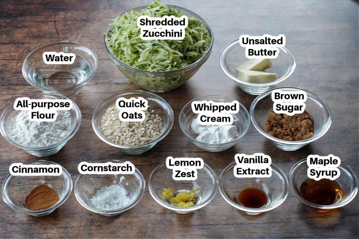 ingredients for zucchini crisp on table in glass containers, labelled