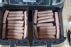 uncooked turkey sausages in single layer in air fryer drawer