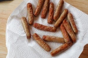 Sausages on plate lined with paper towel