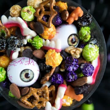 Halloween party mix (with plastic eyeballs) in a black bowl