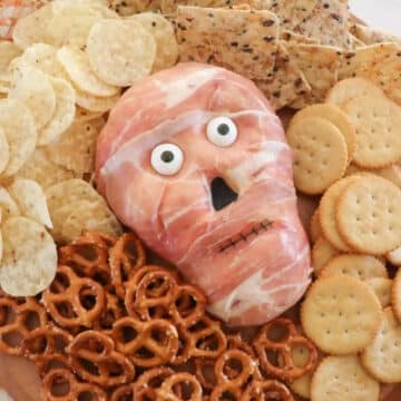 halloween cheese ball surrounded by pretzels, crackers and nachos
