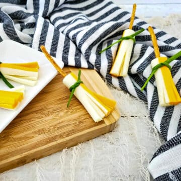 witches broom snacks on a cutting board and on top of navy and white striped linen