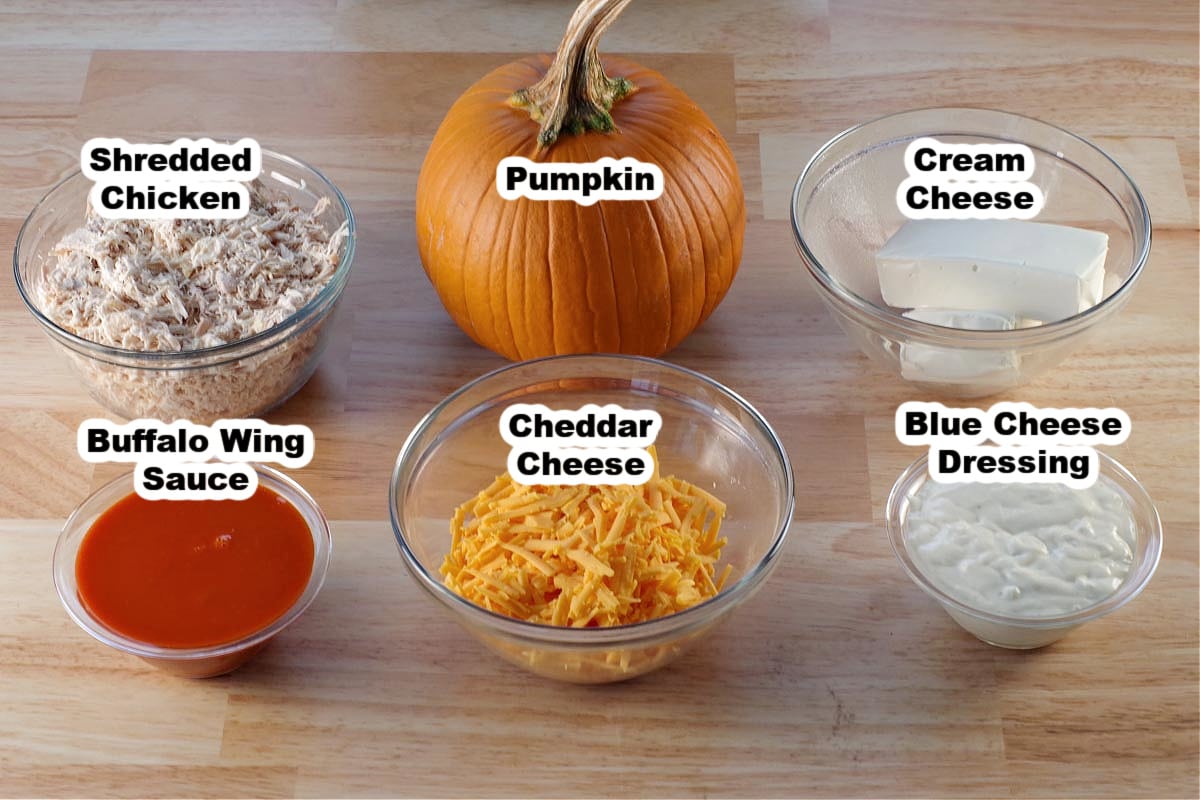 ingredients in Halloween Buffalo chicken dip in glass dishes, labelled