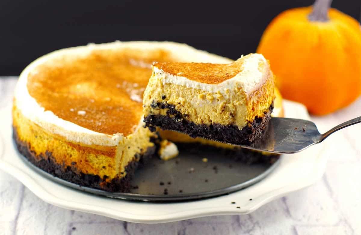 a piece of skinny pumpkin cheesecake being lifted off a plate