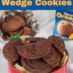 Terry's chocolate orange cookeis in a red Christmas tin with a chocolate orange in the background.