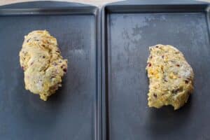 dough divided in 2 on two greased baking sheets