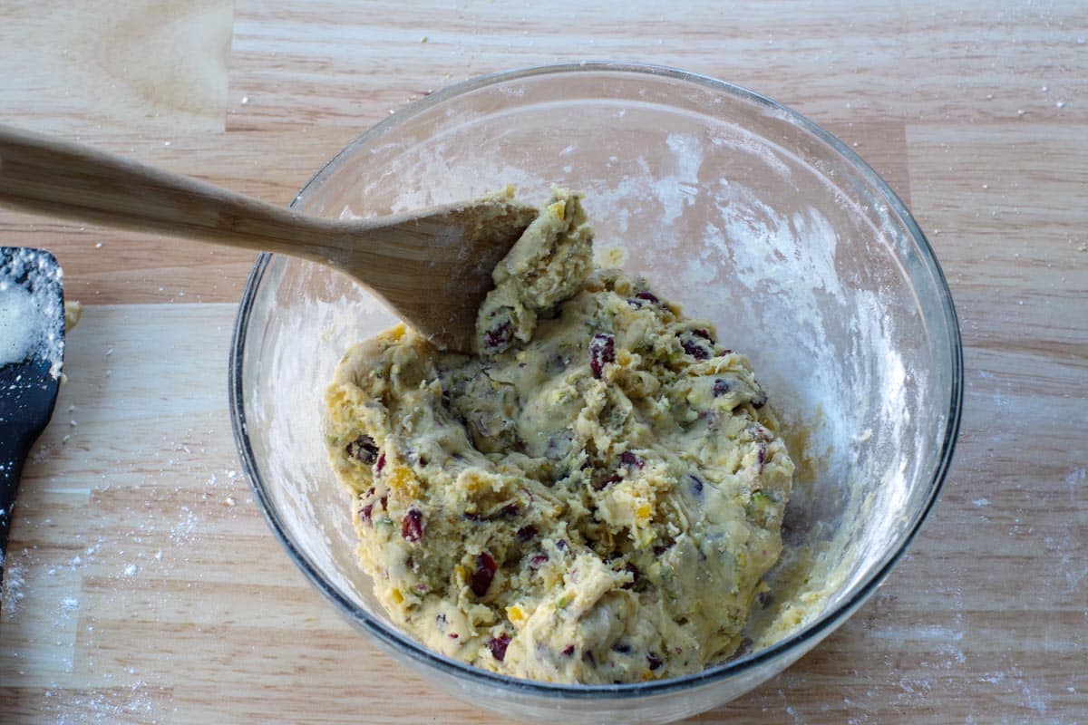 dough in glass bowl with wooden spoon