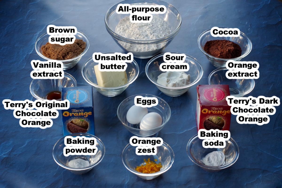 ingredients in Terry's Chocolate Orange Cookies, on blue surface, in glass dishes, labelled