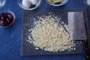 chopped white chocolate on a cutting board with a chef's knife
