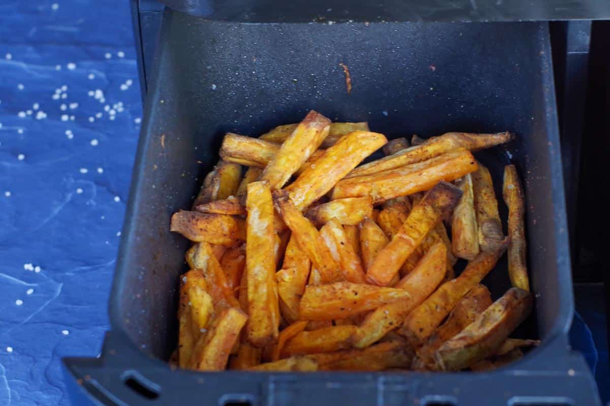 cooked sweet potato fries in drawer of air fryer