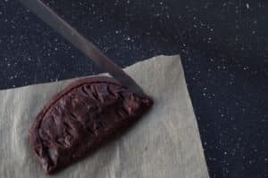 knife being used to make an outline around the half circle edge of the cookie wedge