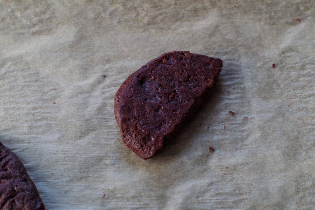 chocolate orange cookie wedge flipped over on parchment paper