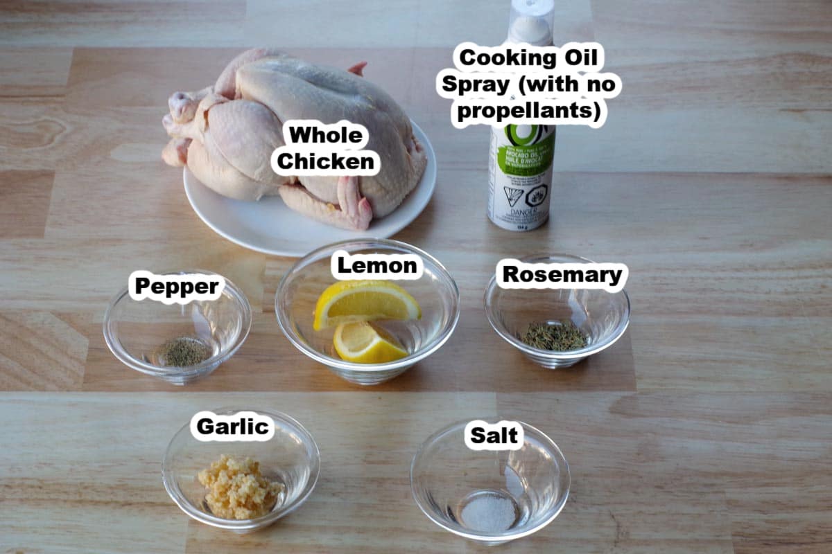 ingredients for air fryer roasted chicken in glass bowls on faux wood surface