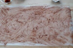 parchment paper with cocoa sprinkled on it