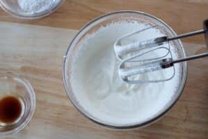 whipping cream beat to soft peaks in glass bowl