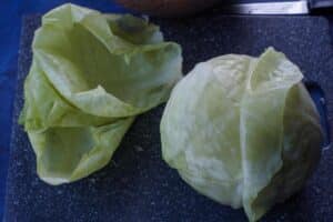 cabbage leaves being peeled off cabbage