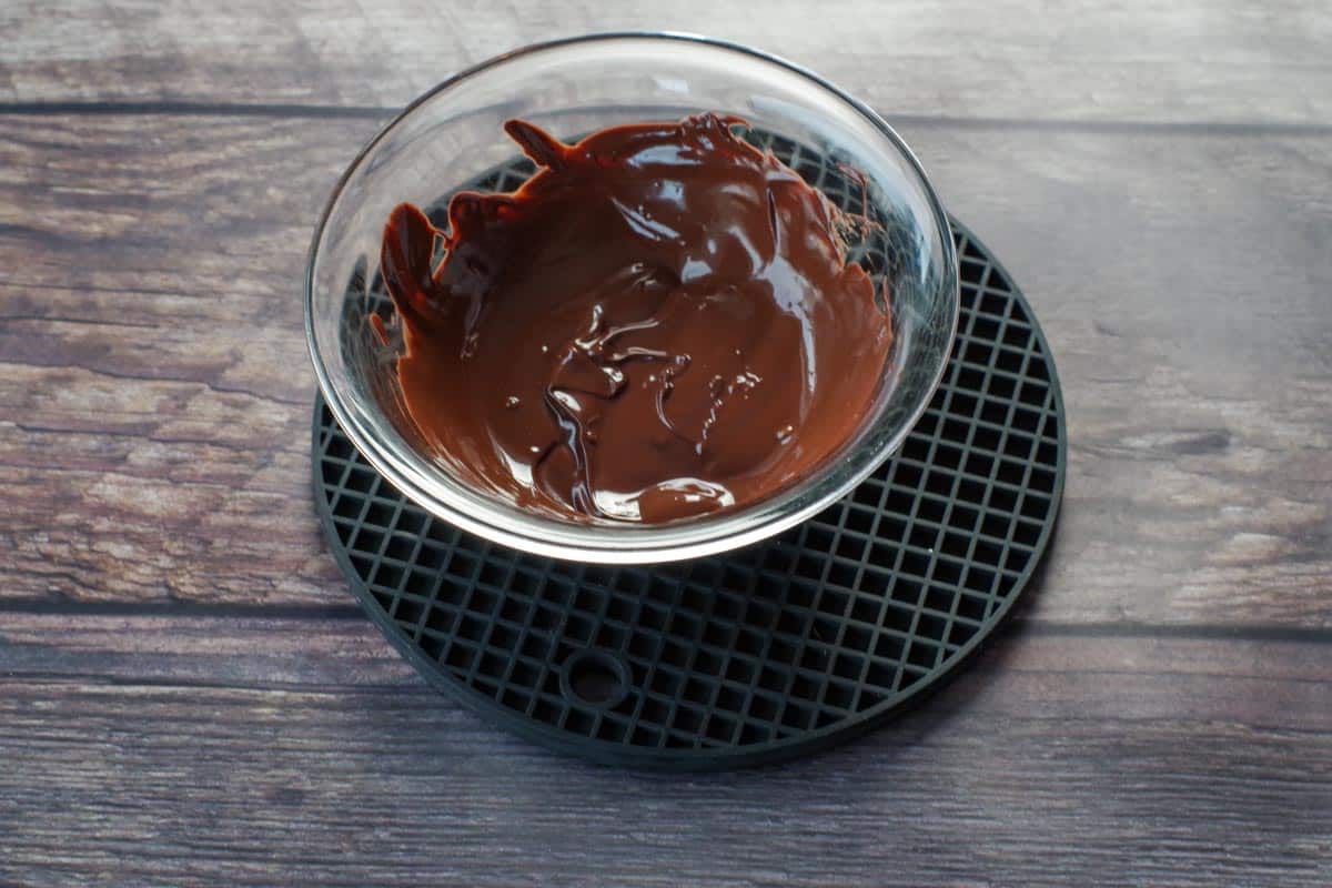 melted chocolate in glass bowl on black trivet
