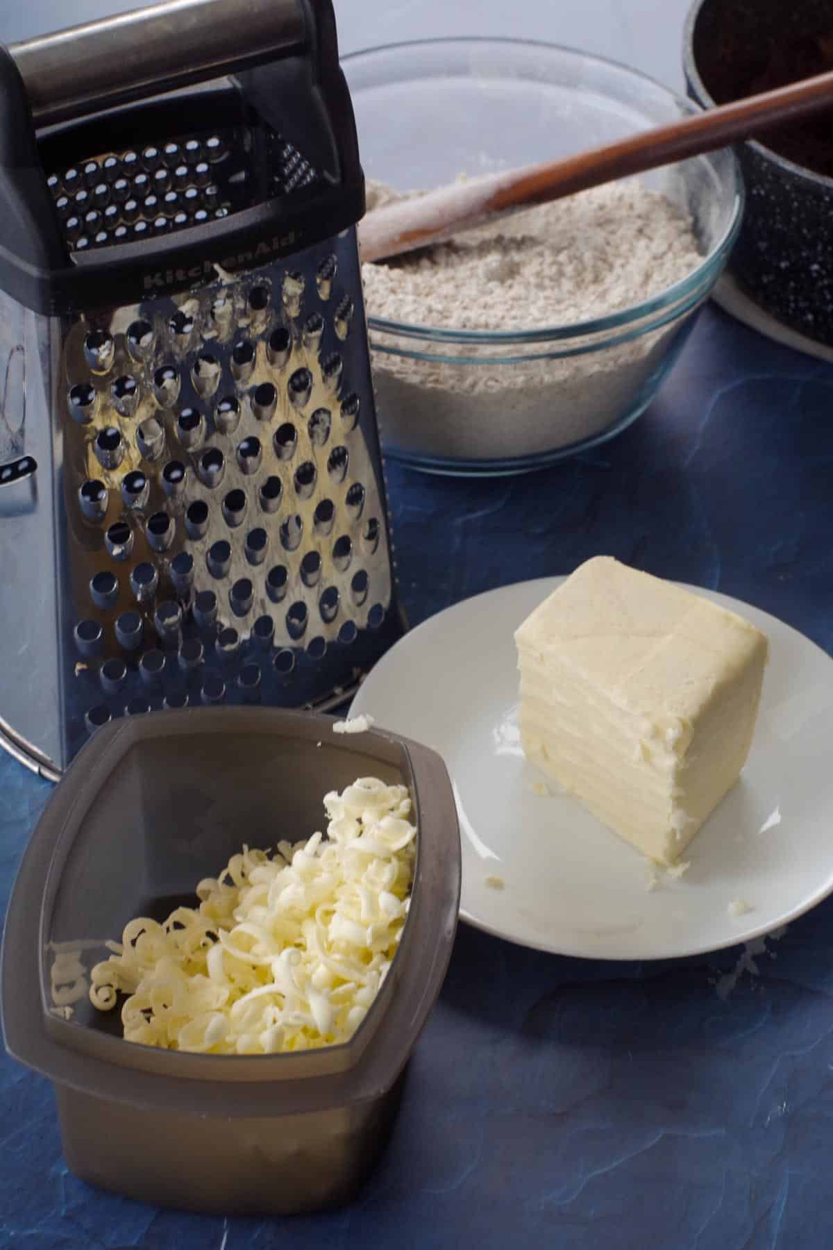 frozen butter being grated for oat topping