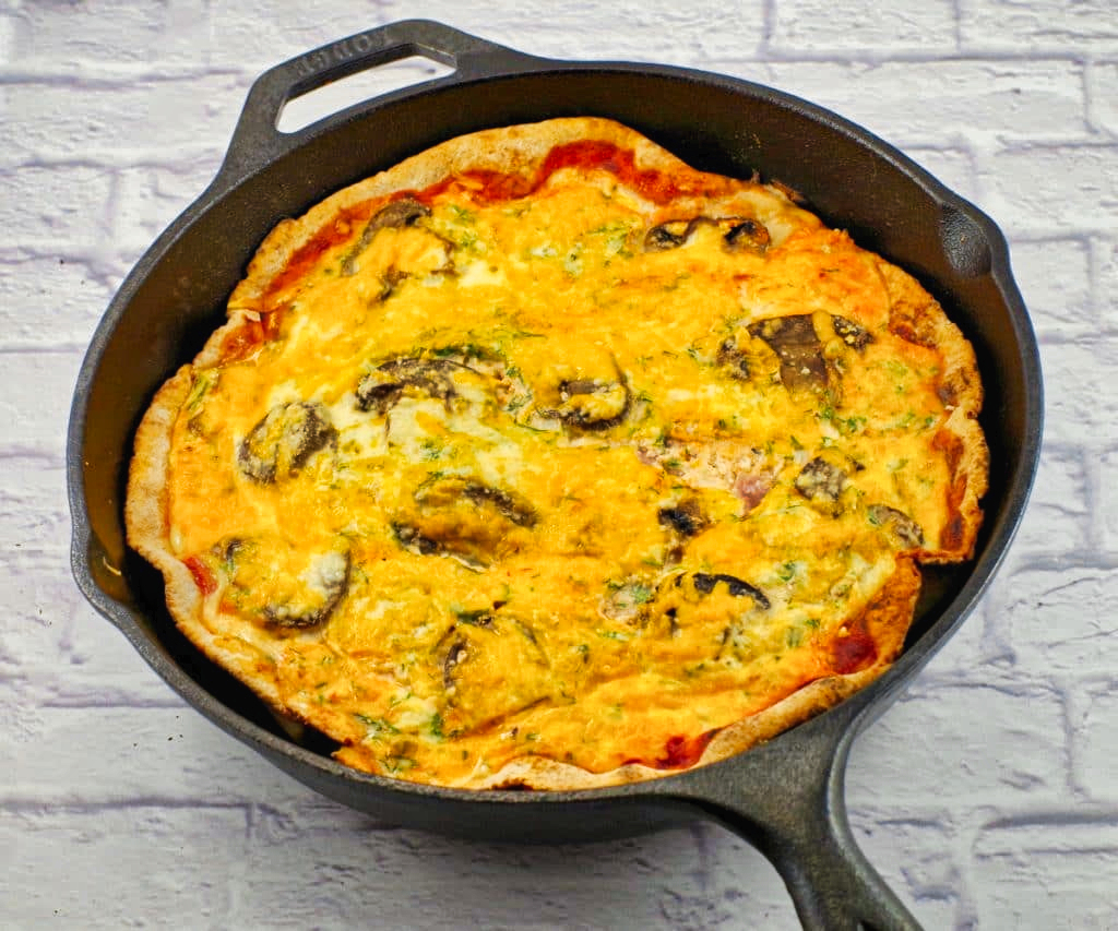 whole baked healthy breakfast pizza in cast iron frying pan