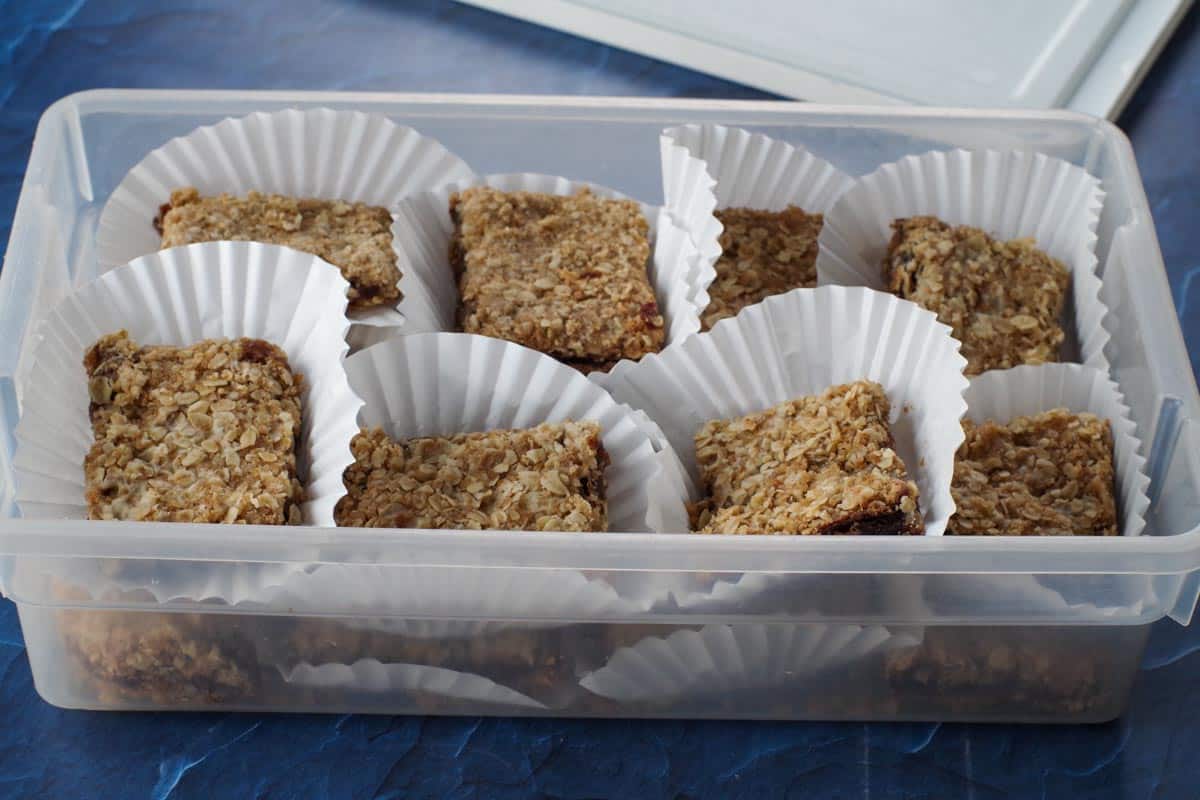 date squares in muffin liners in plastic container