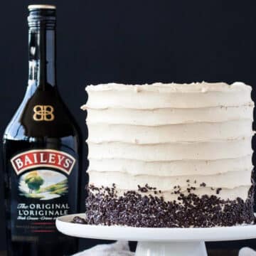 Baileys coffee layer cake beside a bottle of Baileys Irish Cream