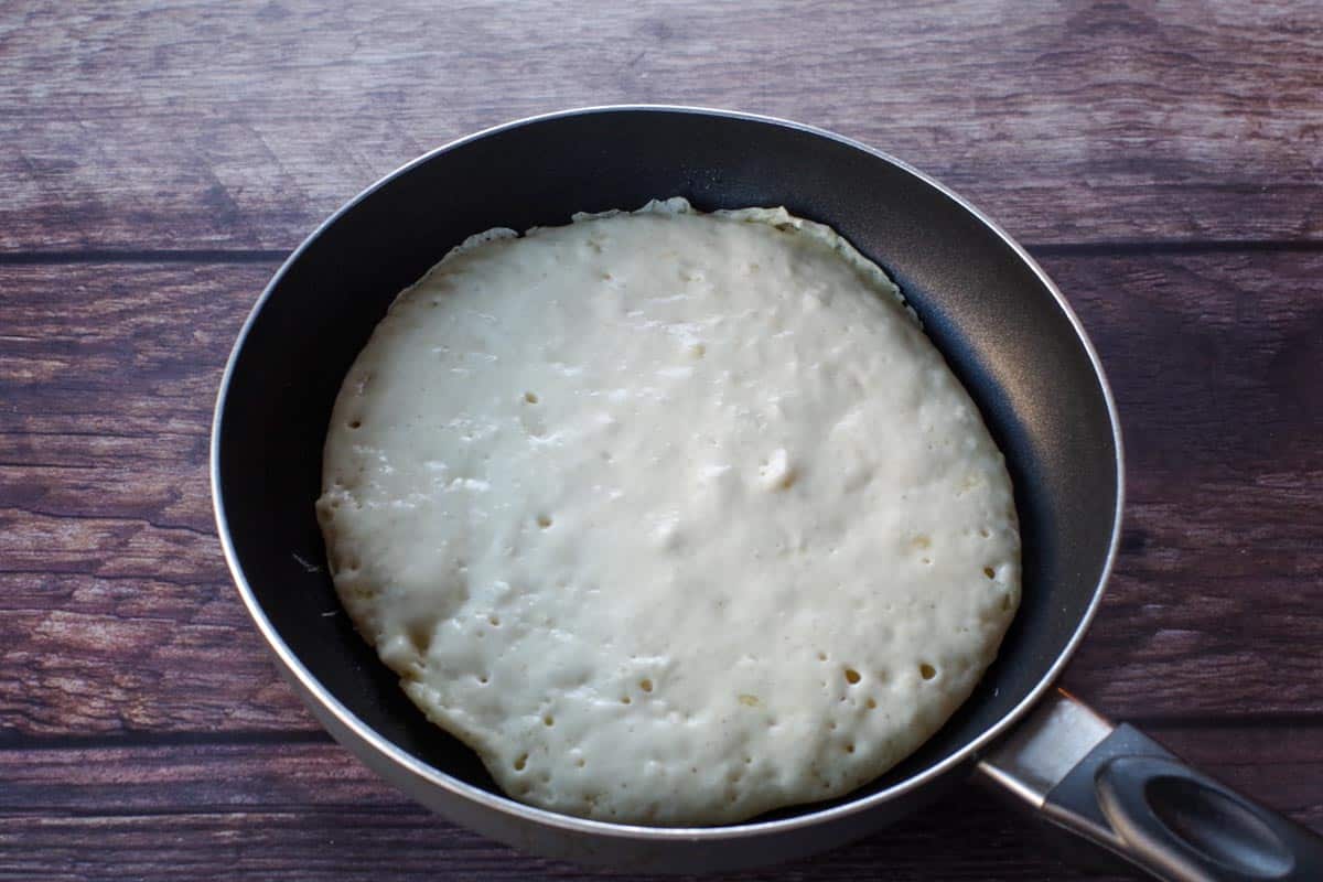 pancake in pan starting to bubble