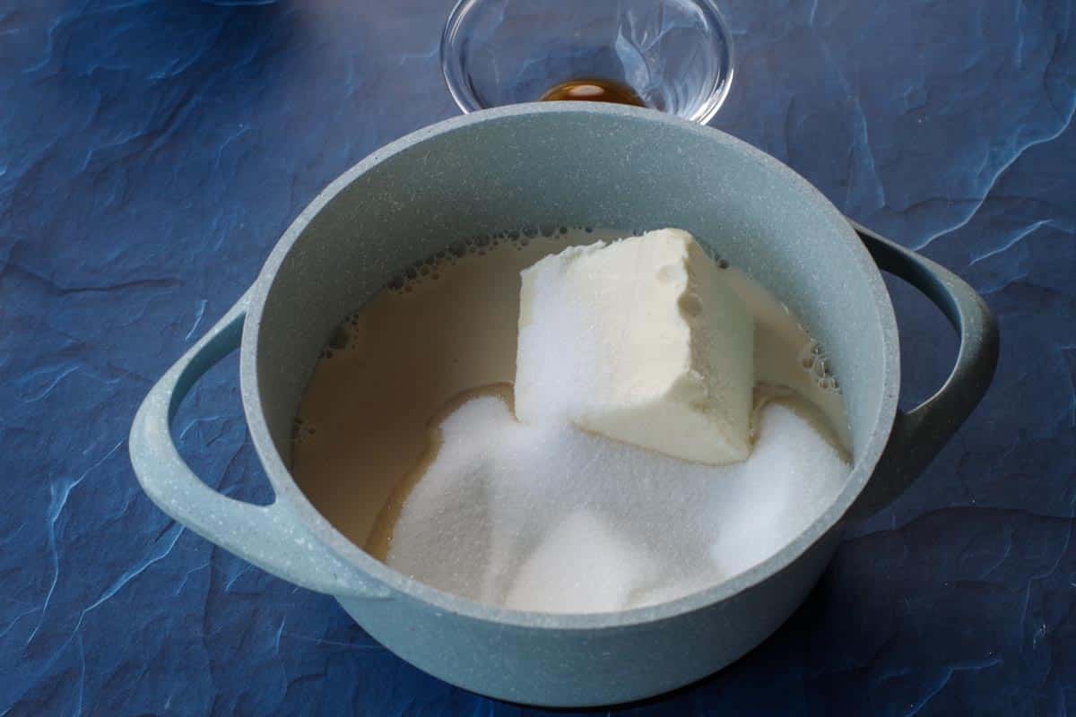 sugar milk and butter in a light blue saucepan